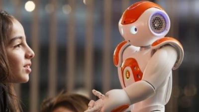 Meisje en robot die elkaar in de 'ogen' kijken.